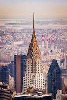 In the center stands the spire of Chrysler Building with its glowing gloden arches and arrows pointing to the sky. Around it are more skyscrapers and other tall buildings. The background is washed out and orangey suggesting the the photo is old.